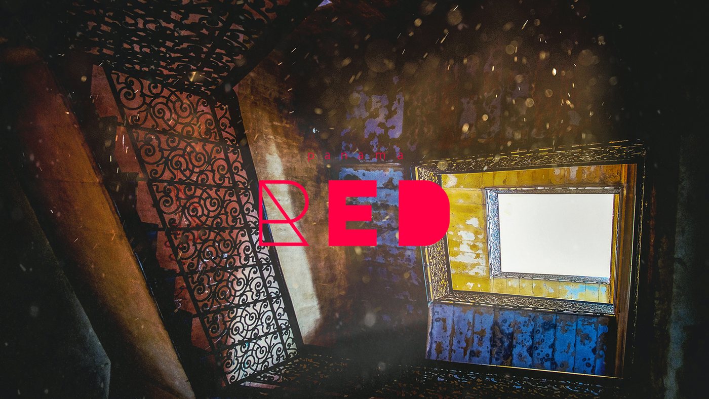 A dark room lit through a carved screen, with RED glowing on the wall.
